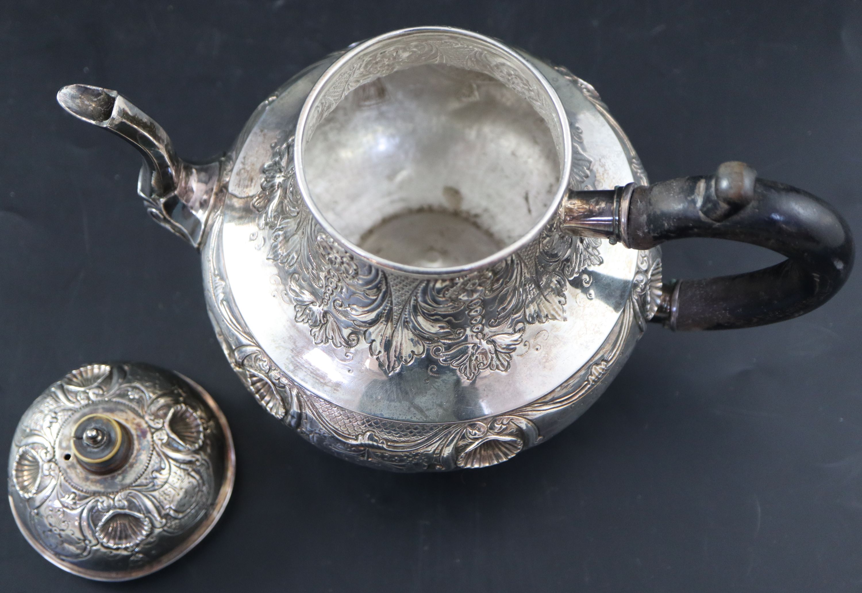 A late 18th/early 19th century Dutch embossed white metal pear shaped teapot, height 15.3cm, gross 10oz.